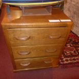 An oak chest fitted three drawers on bracket feet