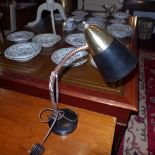 A 1950`s desk lamp with black painted shade on adjustable supports