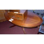 An inlaid mahogany low table the oval top raised on quadruped swept supports and castors