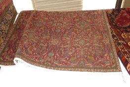 An extremely fine central Persian Varamin rug repeating floral and bird motifs on a rouge field with