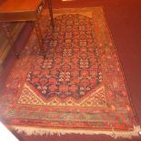 An Iranian antique Malayer carpet with stylised motifs on a midnight blue field surrounded by