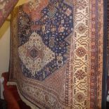 A Caucasian design carpet with three diamond lozenges on a midnight blue field with one frieze and