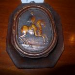 A C19th wax plaque with knight on horseback in relief in an oak frame