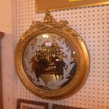 A C19th looking glass with circular mirror plate having etched floral decoration  within carved