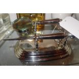 A chromed desk stand with letter opener and magnifying glass