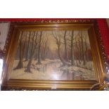 An oil on board winter landscape in the woods in a heavy giltwood frame