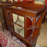 An Edwardian mahogany display cabinet with glazed panel flanked by carved column having base drawer