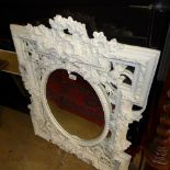 A French style white painted wall mirror the oval bevelled plate with carved frame