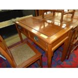 A Chinese hardwood dressing/side table with two drawers on tapered support
