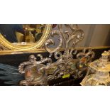 A wall mirror the shaped plate with carved silver foliate frame