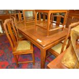 A Chinese hardwood dining table and eight matching chairs including two carvers