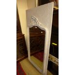 A distressed plated wall mirror the bevelled arched plate with carved foliate relief