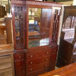 A mahogany bookcase with glazed panels and cupboards on plinth base