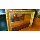 A large wall mirror the rectangular bevelled plate in gilded plate