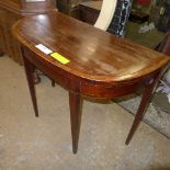 A George III mahogany inlaid table the foldover top raised on tapered supports