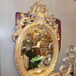 A gilded pier mirror the oval bevelled plate with carved acanthus frame