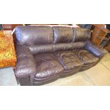 A three seater sofa upholstered in cognac leather on block feet
