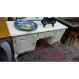 A French white painted desk the rectangular top above drawer flanked by cupboards