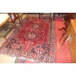 A contemporary carpet with two central medallions on red field