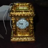 A gilted miniature carriage clock