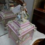 A porcelain casket with cherub decoration