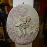 A pair of wall hanging plaques depicting courting couples