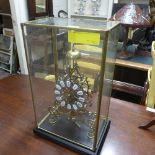 A skeleton clock within glass case