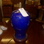 A bulbous blue table lamp