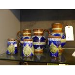 A collection of Royal Lambeth blue glazed pottery commemorative jugs and mugs
