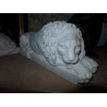A pair of recumbent marble lions on stand