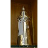 A silver plated cocktail shaker in the form of a lighthouse