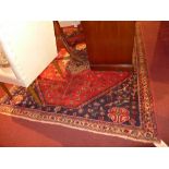 A Persian Abadell rug with central pendant medallion on a terracotta field in geometric border