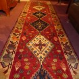 A fine South West Persian Qashgai runner 335 x 83 cm repeating goul motifs on a terracotta field