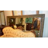 A C19th mirror of large size the rectangular plate within giltwood and gesso frame
