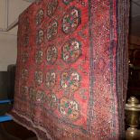 A fine North East Persian Turkoman rug 205 x 115 cm repeating goul motifs on a terracotta field