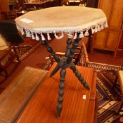 A Victorian ebonised gypsy table with velour lined top and raised on bobbin turned supports together