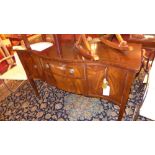 A Georgian style mahogany sideboard fitted single drawer flanked by cupboard doors on tapering