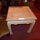An Eastern limed pine side table raised on square section supports