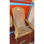 An Eastern carved teak steamer chair with caned back and seat (AF)