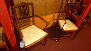 A pair of Edwardian mahogany elbow chairs with upholstered pad seats on stretchered supports