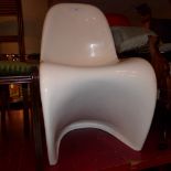 A contemporary designer S shaped chair in white fiberglass