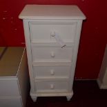 A white painted chest fitted four drawers and raised on turned supports
