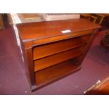 A mahogany open bookcase on plinth base