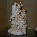 A Continental porcelain figure group of four cherubs heightened in gilt