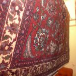 An extremely fine central Persian Kashan carpet signed 393 x 275 cm bearing central floral pendant