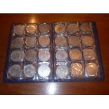 A collection of various white metal replica coins