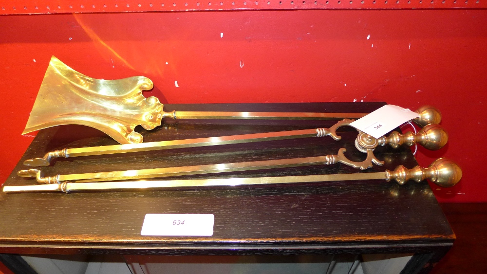 A set of three brass fire side utensils comprising shovel, poker and tongs