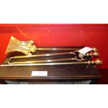 A set of three brass fire side utensils comprising shovel, poker and tongs