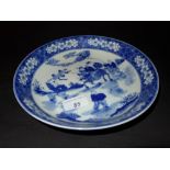 A Chinese blue and white shallow dish decorated with pictorial reserves