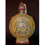 A Chinese lidded moon flask decorated in yellow glaze and heightened in gilt